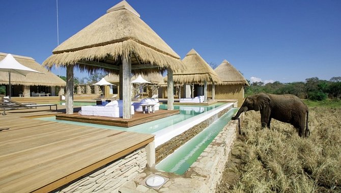 Großer Pool und Brunnen aus dem ein Elefant trinkt